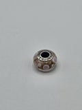 Pandora Amber and Pink Polka Dot Murano Glass Charm on a plain light background