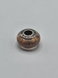 Pandora Amber Glow Murano Glass Charm on a plain light background