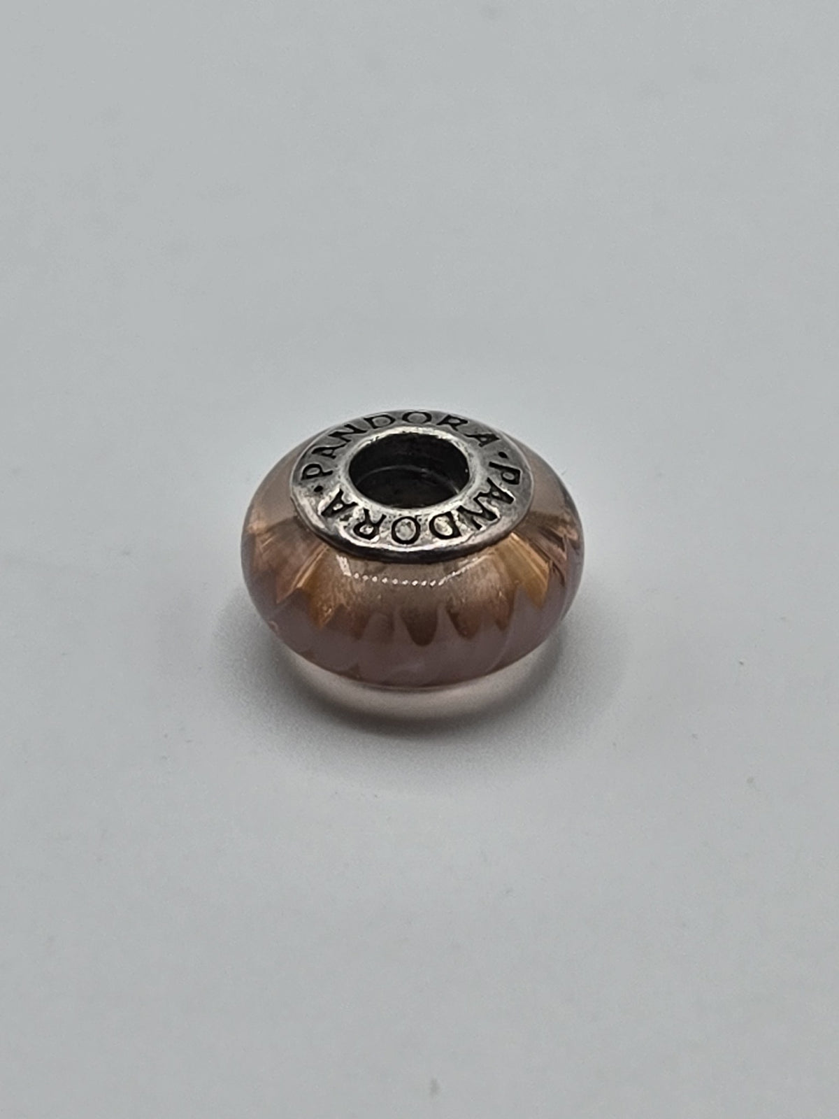 Pandora Amber Glow Murano Glass Charm on a plain light background