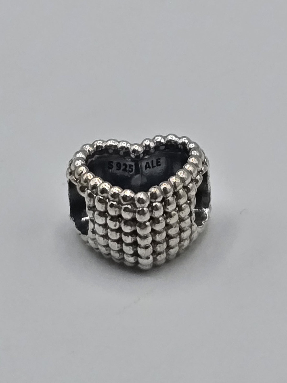 Pandora Beaded Heart Charm on a plain light background