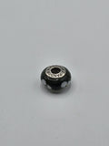 Pandora Black and White Flower Murano Glass Charm on a plain light background