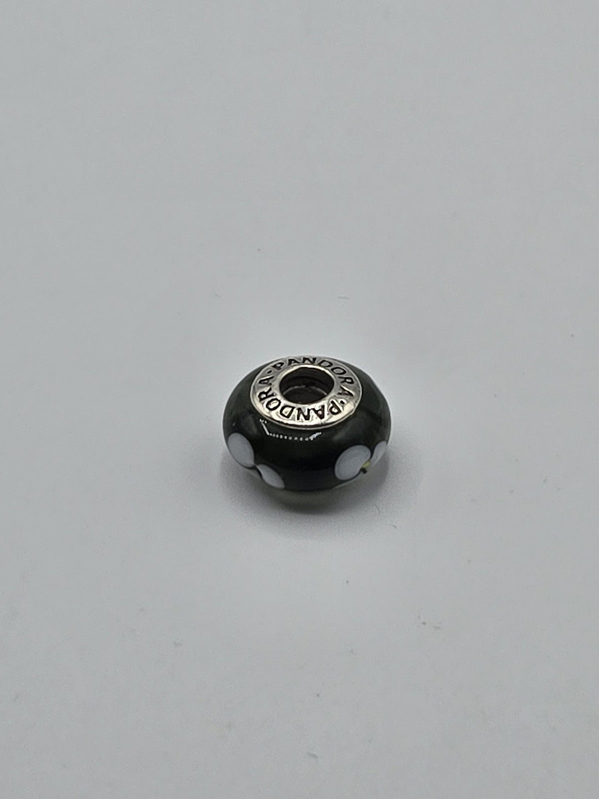 Pandora Black and White Flower Murano Glass Charm on a plain light background