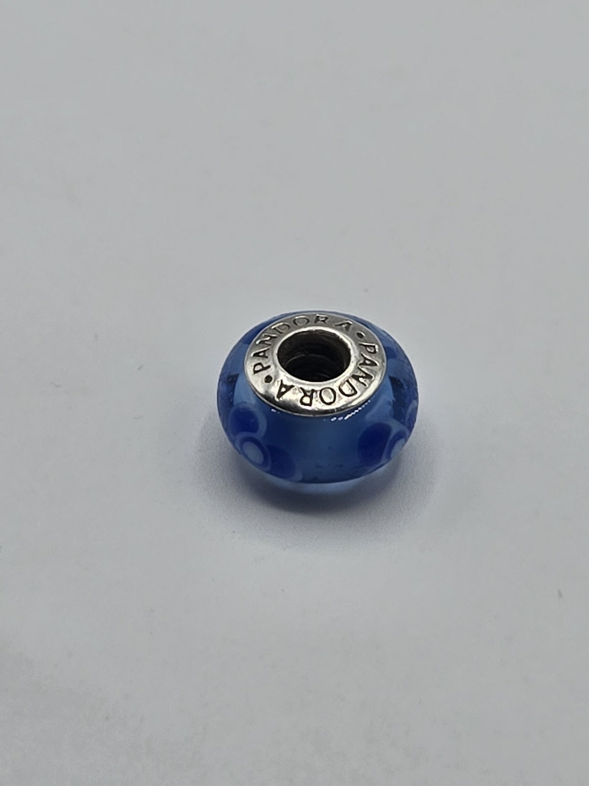 Pandora Blue Circle Murano Glass Charm on a plain light background