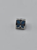 Pandora Blue Enamel Petal Triangle Charm on a plain light background