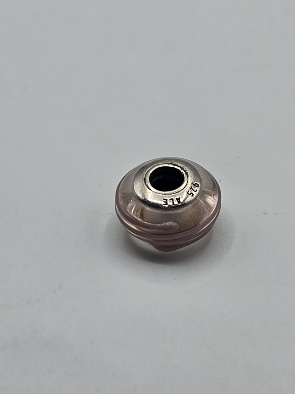 Pandora Blush and Gold Swirl Murano Glass Charm on a plain light background
