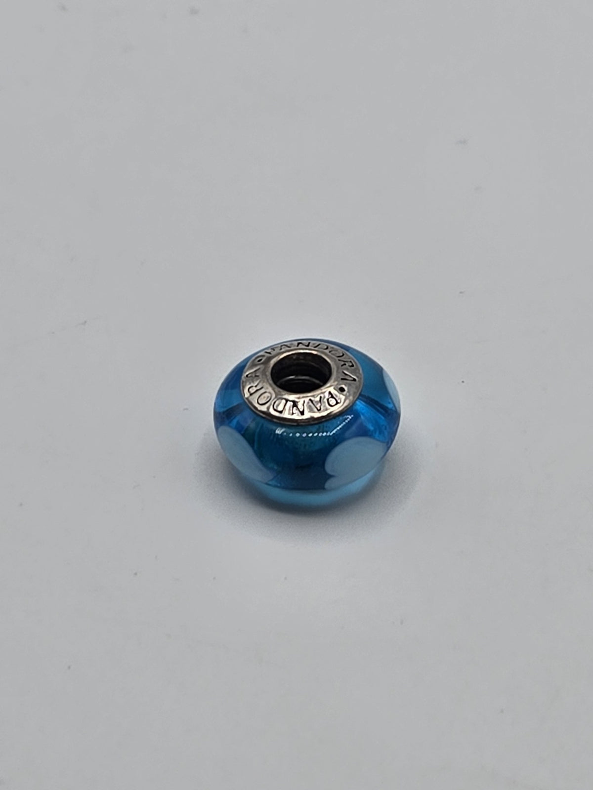 Pandora Bright Blue and Pale Blue Circle Murano Glass Charm on a plain light background