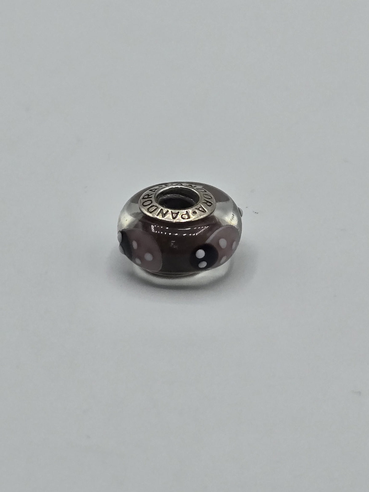Pandora Brown Pink and Black Polka Dot Murano Glass Charm on a plain light background