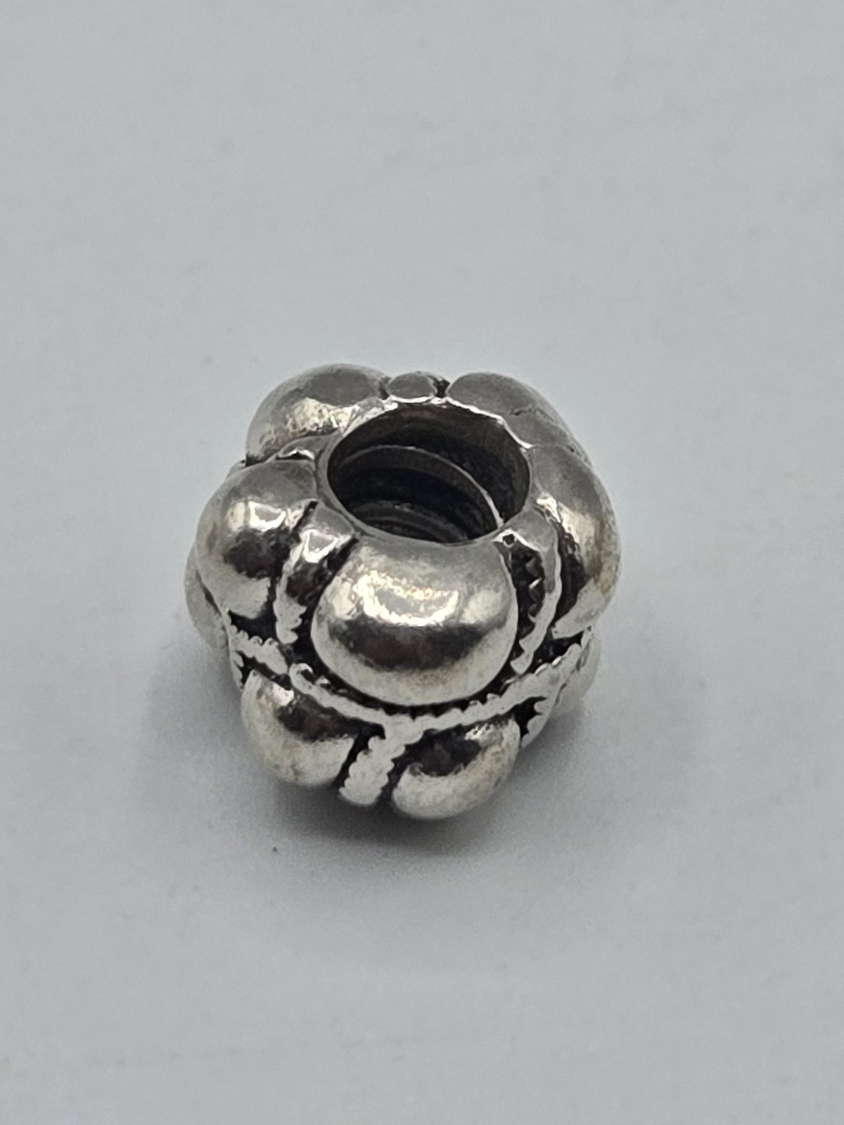 Pandora Bubbles and Rope Charm on a plain light background