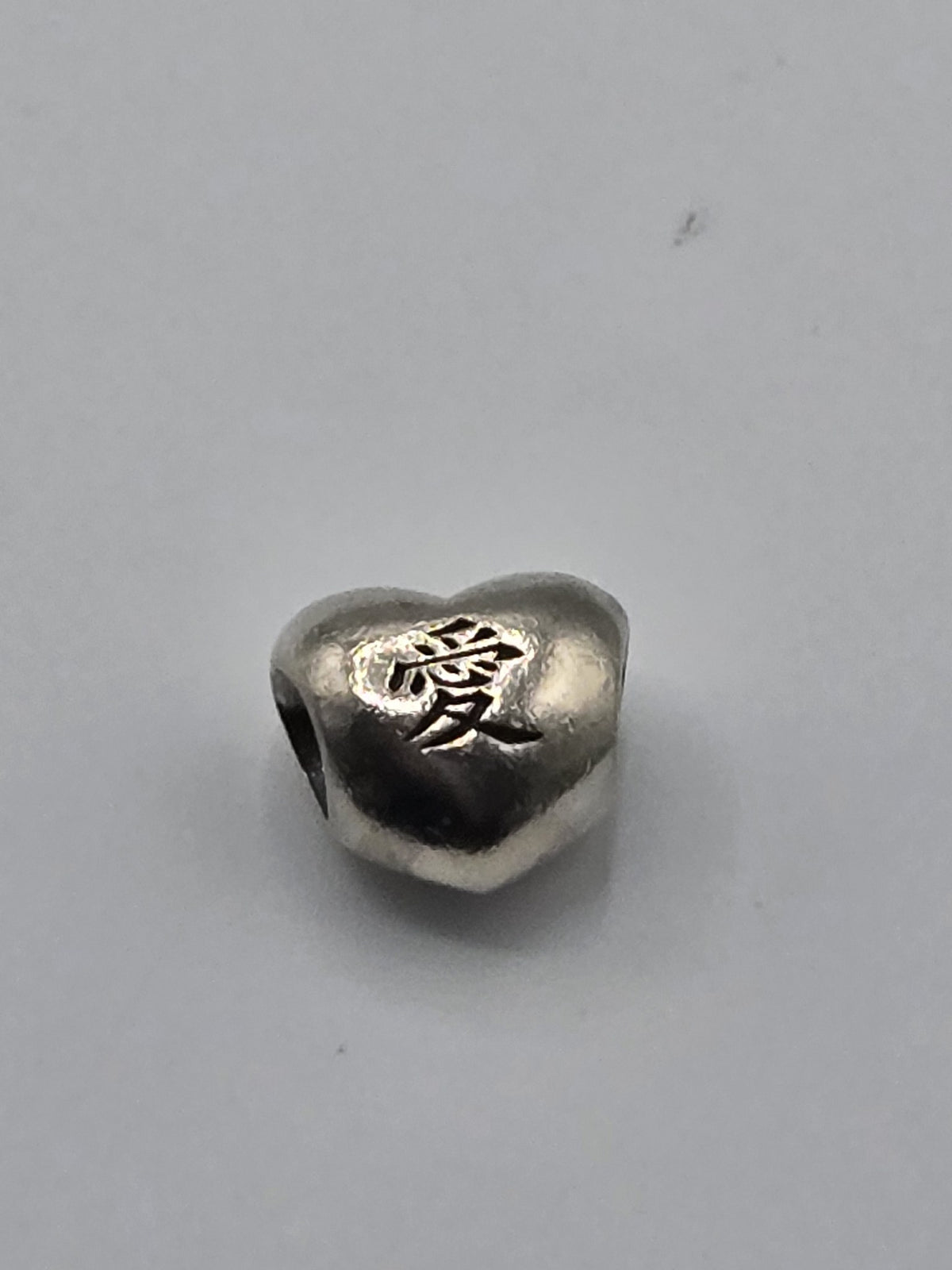 Pandora Chinese Love Character Heart Charm on a plain light background
