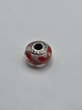 Pandora Clear and Red Heart Swirl Murano Glass Charm on a plain light background