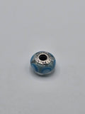 Pandora Clear and Sky Blue Circle Murano Glass Charm on a plain light background