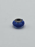 Pandora Cobalt Blue Ribbed Swirl Murano Glass Charm on a plain light background