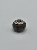 Pandora Dark Brown Textured Wood-Look Charm on a plain light background