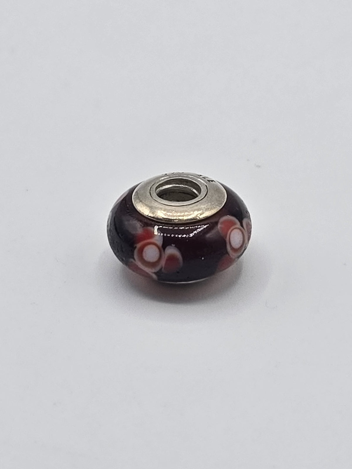 Pandora Deep Purple and Coral Flower Murano Glass Charm on a plain light background
