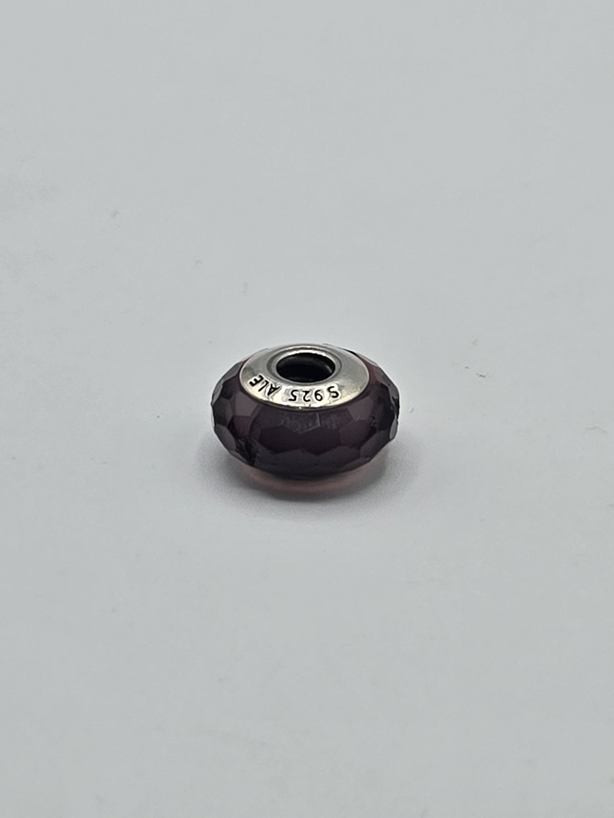 Pandora Deep Purple Faceted Murano Glass Charm on a plain light background