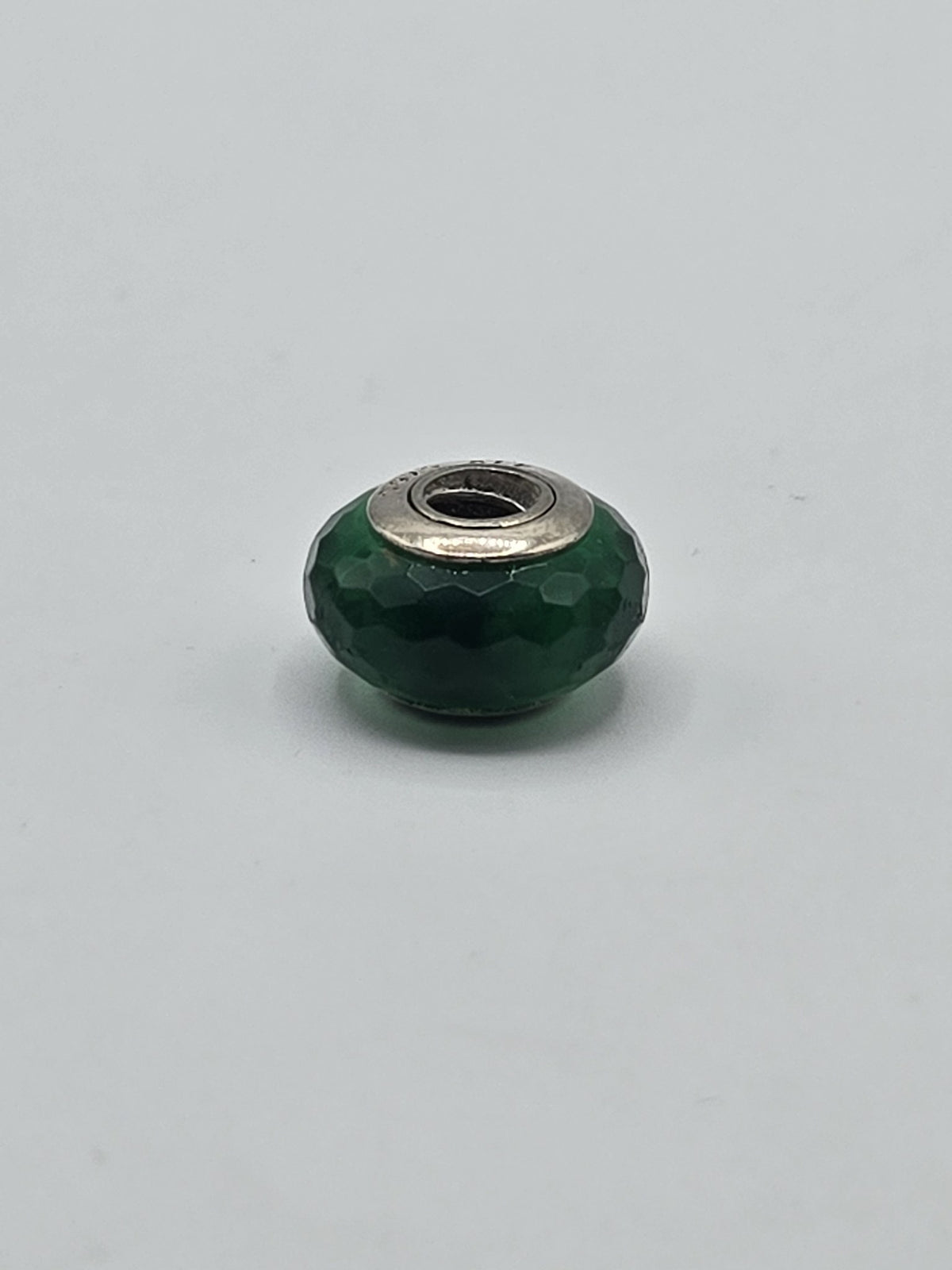 Pandora Emerald Green Faceted Murano Glass Charm on a plain light background