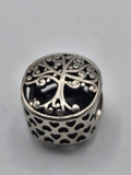 Pandora Family Roots Charm on a plain light background