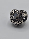 Pandora Filigree Heart Charm with Grey Stone on a plain light background