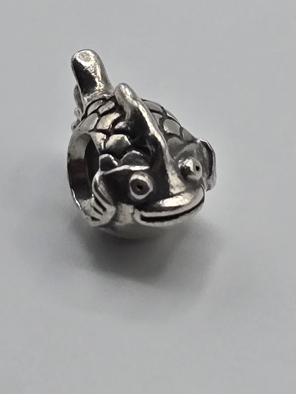 Pandora Fish Charm on a plain light background