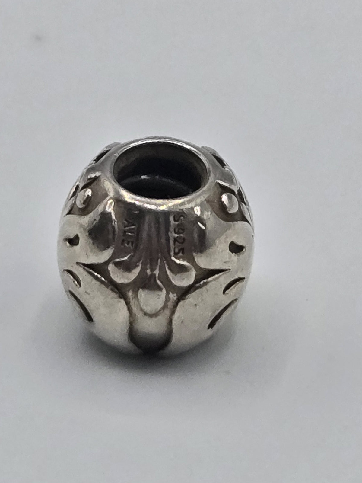 Pandora Fleur de Lis Charm on a plain light background