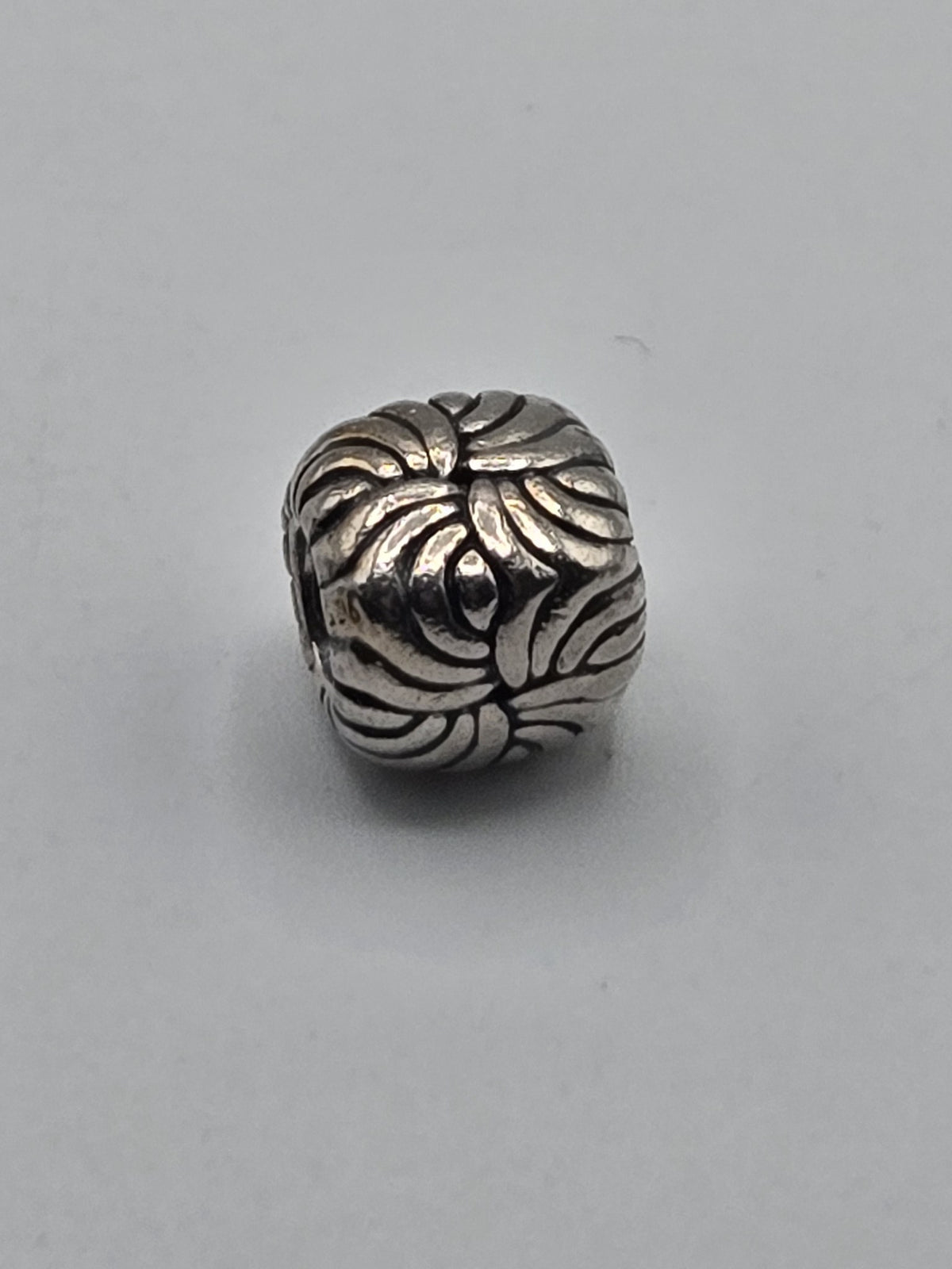 Pandora Floral Swirl Charm on a plain light background