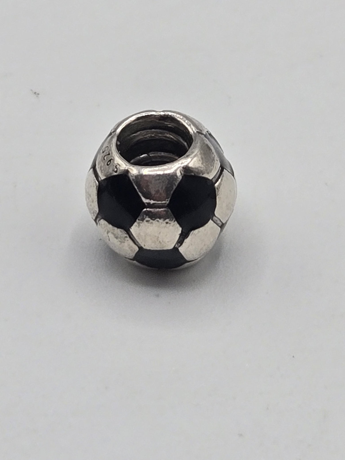Pandora Football Charm on a plain light background