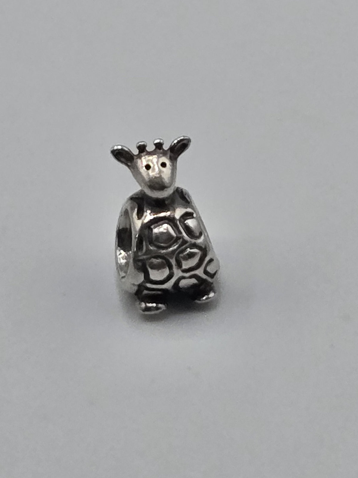 Pandora Giraffe Charm on a plain light background