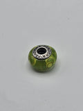 Pandora Green and Yellow Circle Murano Glass Charm on a plain light background