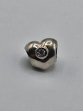 Pandora Heart Charm with Clear Stone on a plain light background