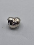 Pandora Heart Charm with Pale Pink Stone on a plain light background