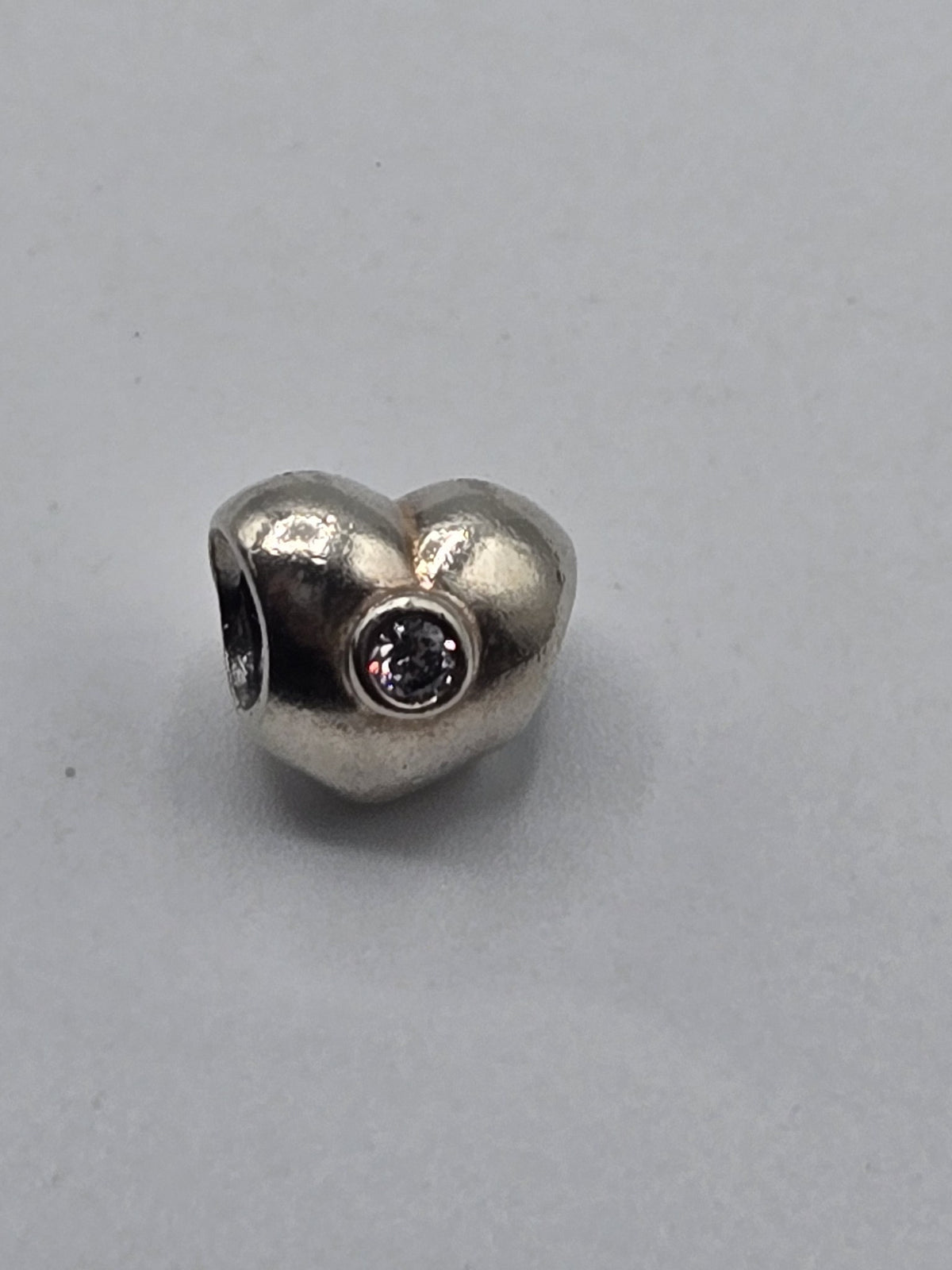 Pandora Heart Charm with Pale Pink Stone on a plain light background