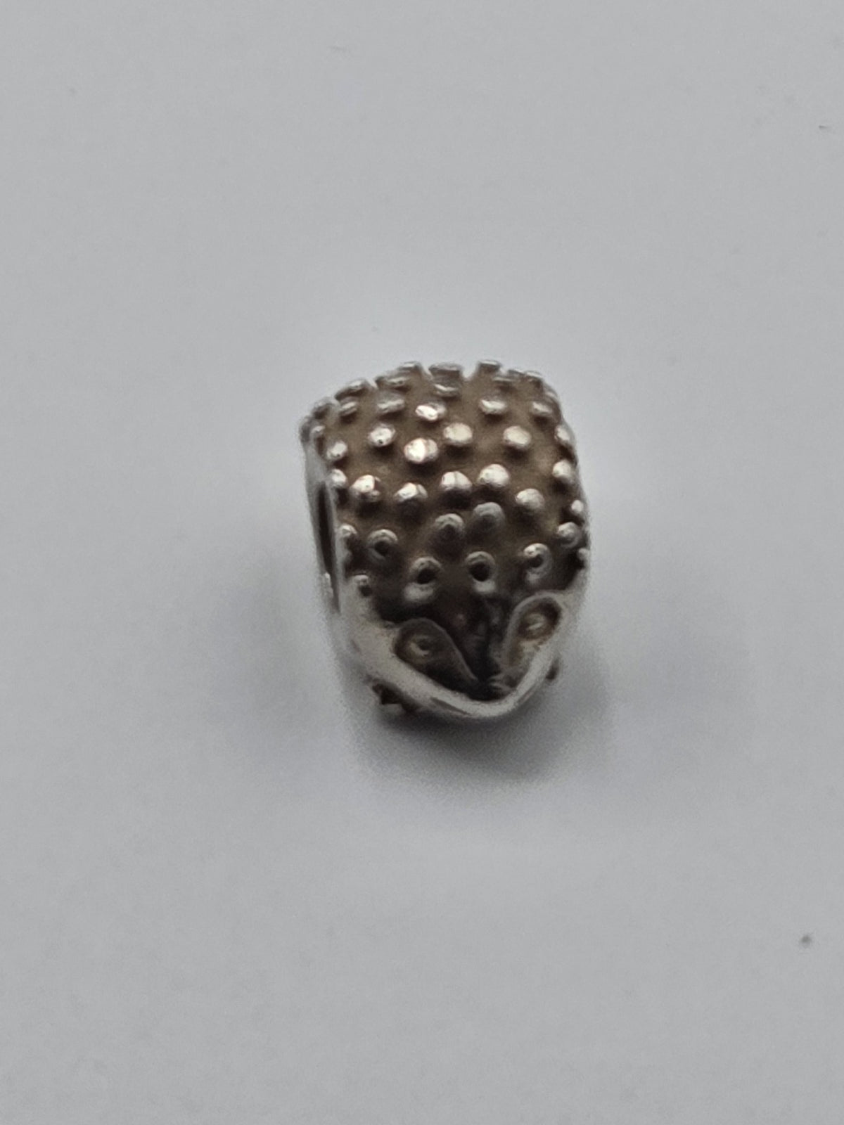 Pandora Hedgehog Charm on a plain light background