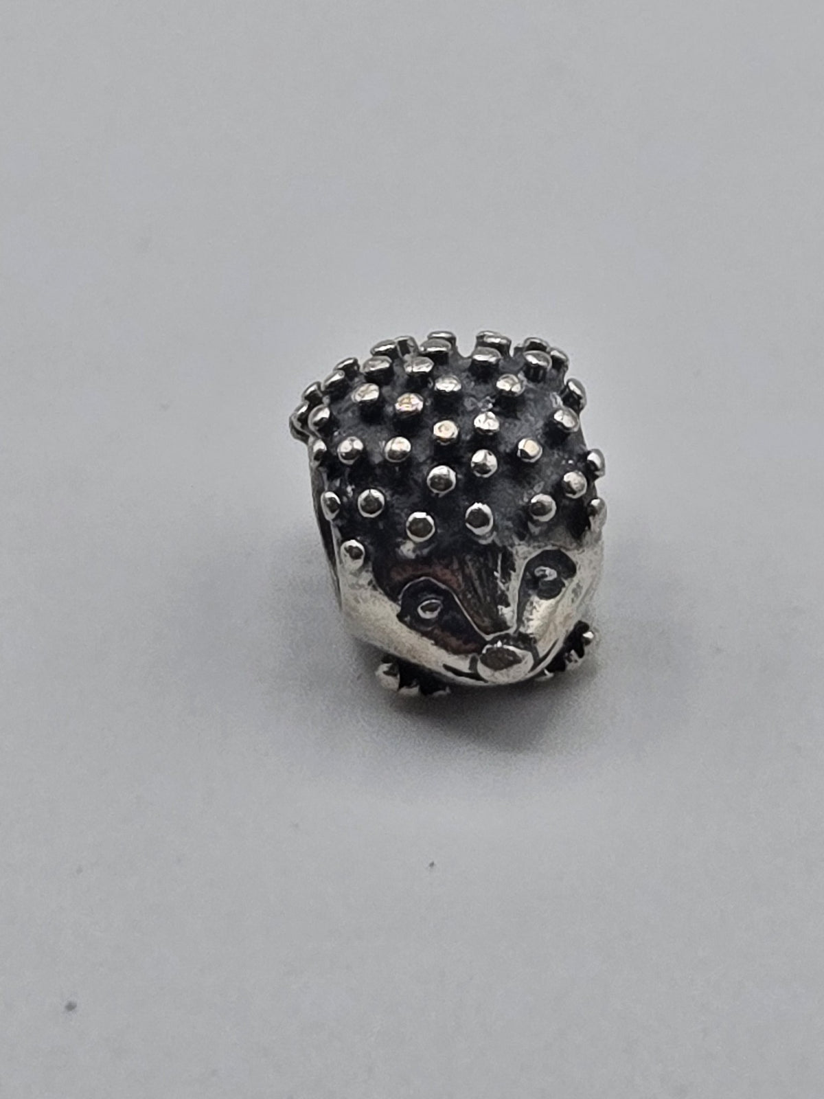 Pandora Hedgehog Charm on a plain light background