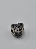 Pandora Lace Heart Charm on a plain light background