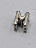 Pandora Letter M Charm on a plain light background