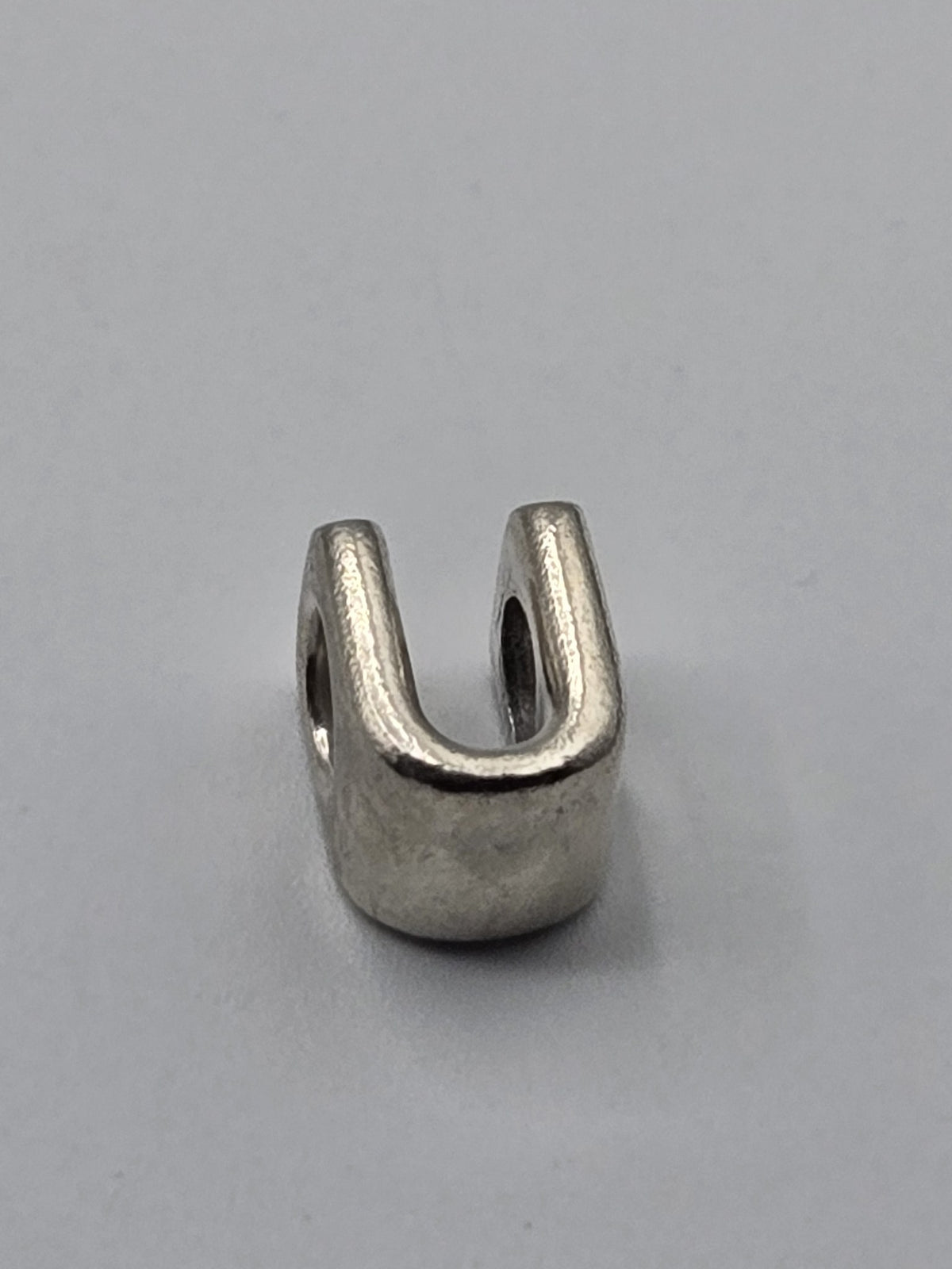 Pandora Letter U Charm on a plain light background