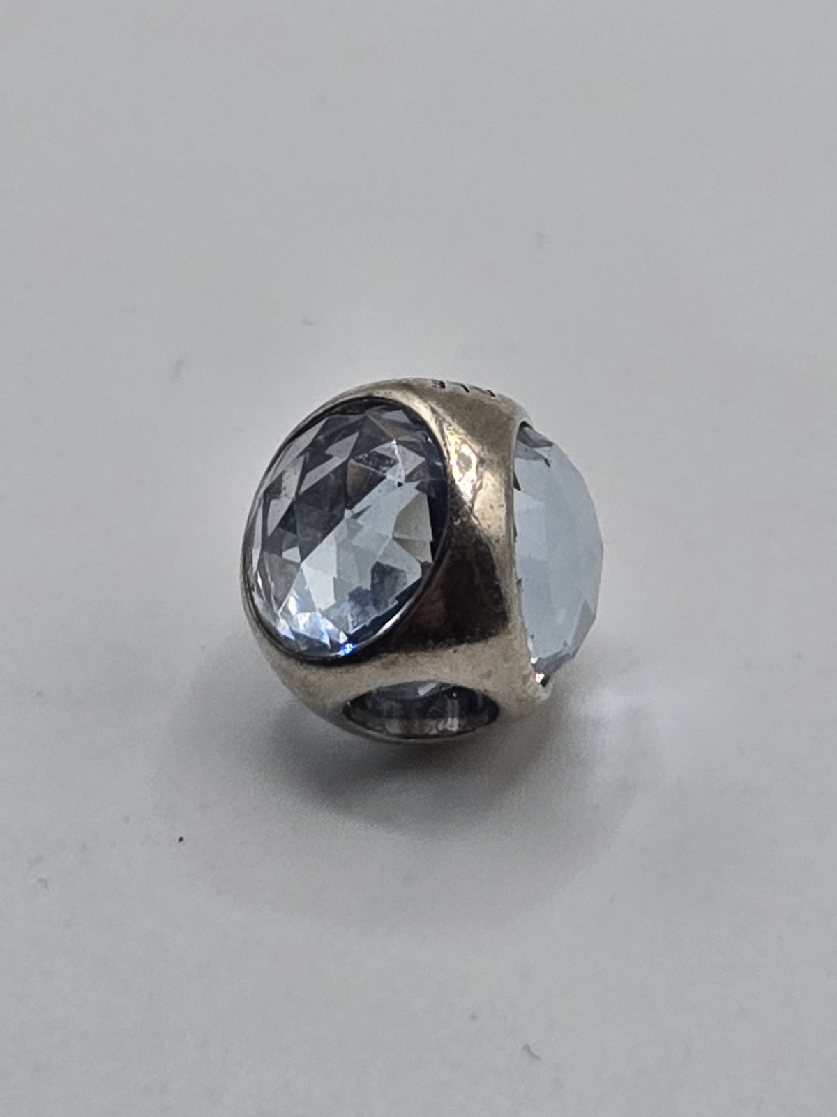 Pandora Light Blue Faceted Crystal Charm on a plain light background