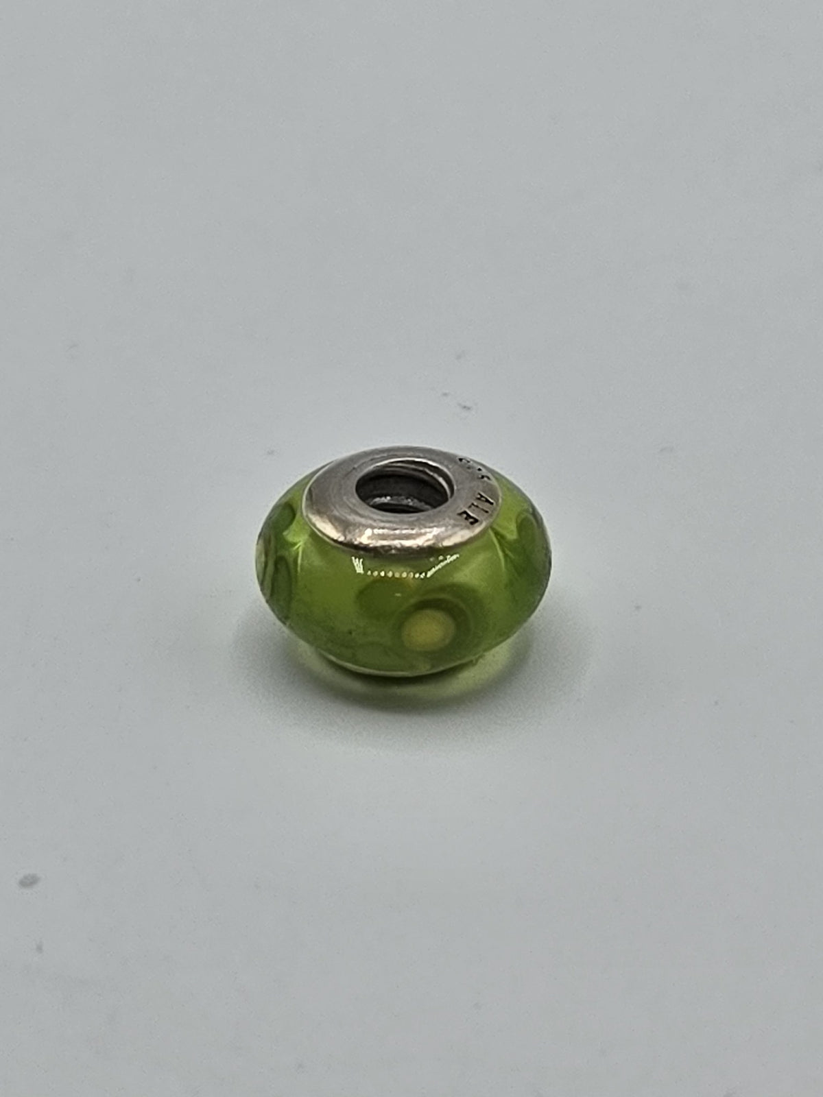 Pandora Lime Green Yellow Flower Murano Glass Charm on a plain light background