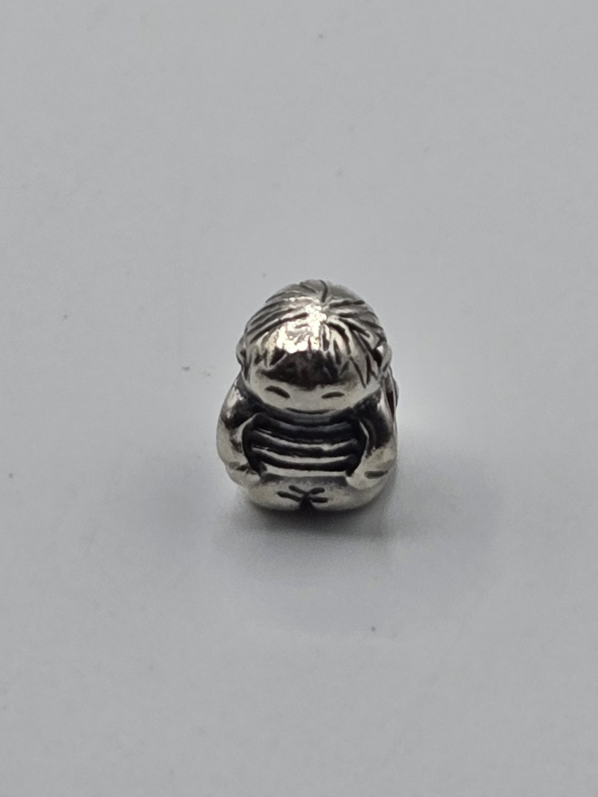 Pandora Little Boy Charm on a plain light background