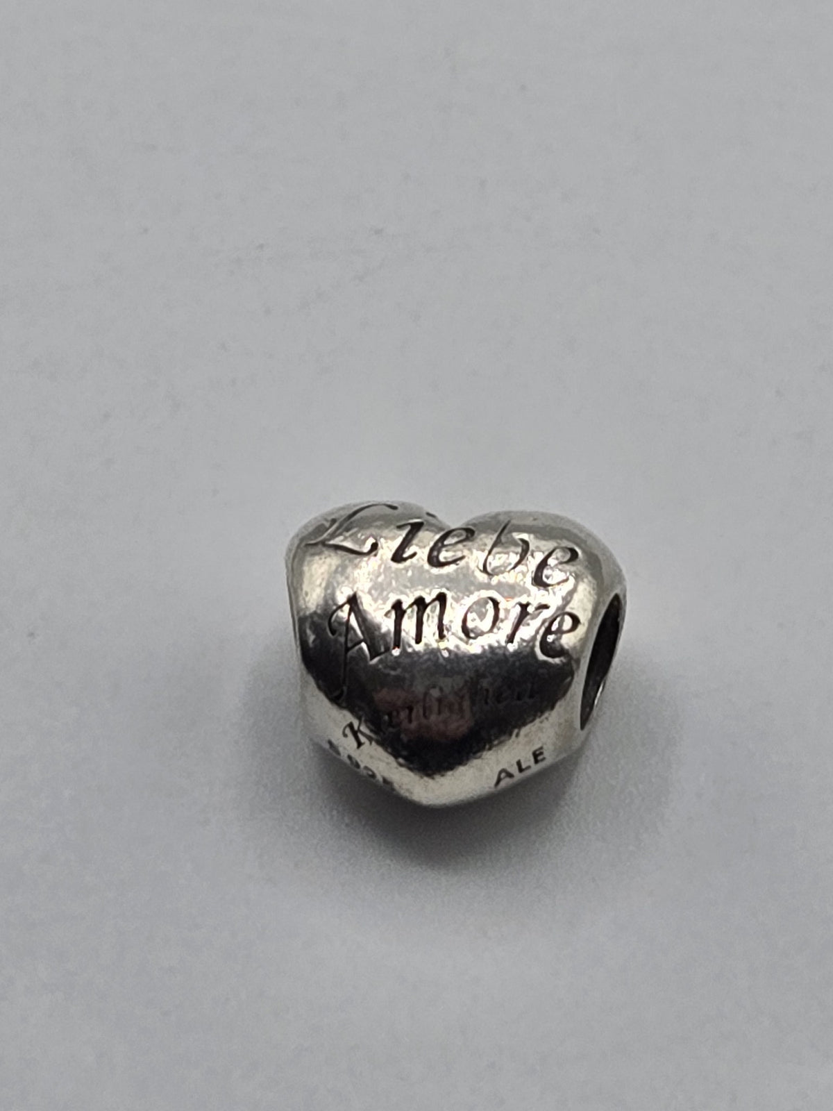Pandora Love Languages Heart Charm on a plain light background