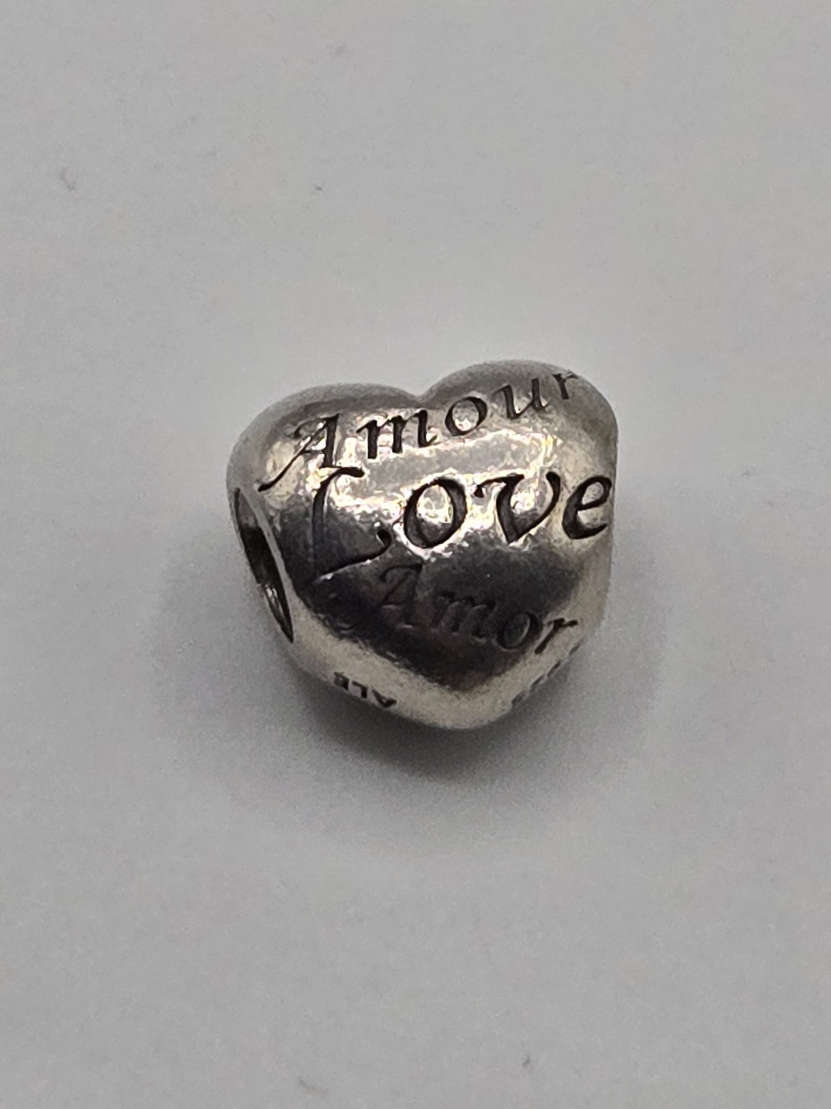 Pandora Love Languages Heart Charm on a plain light background