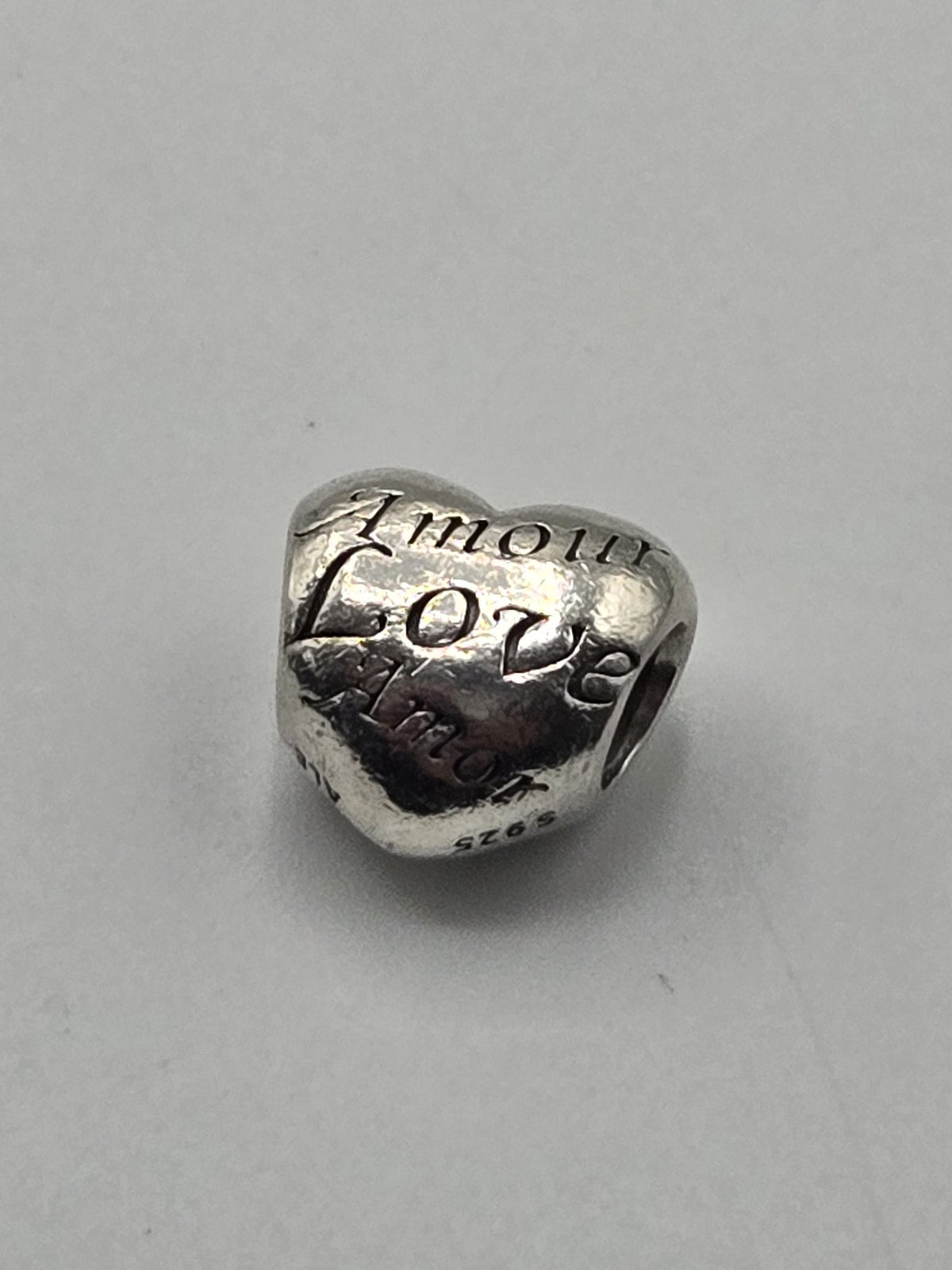 Pandora Love Languages Heart Charm on a plain light background