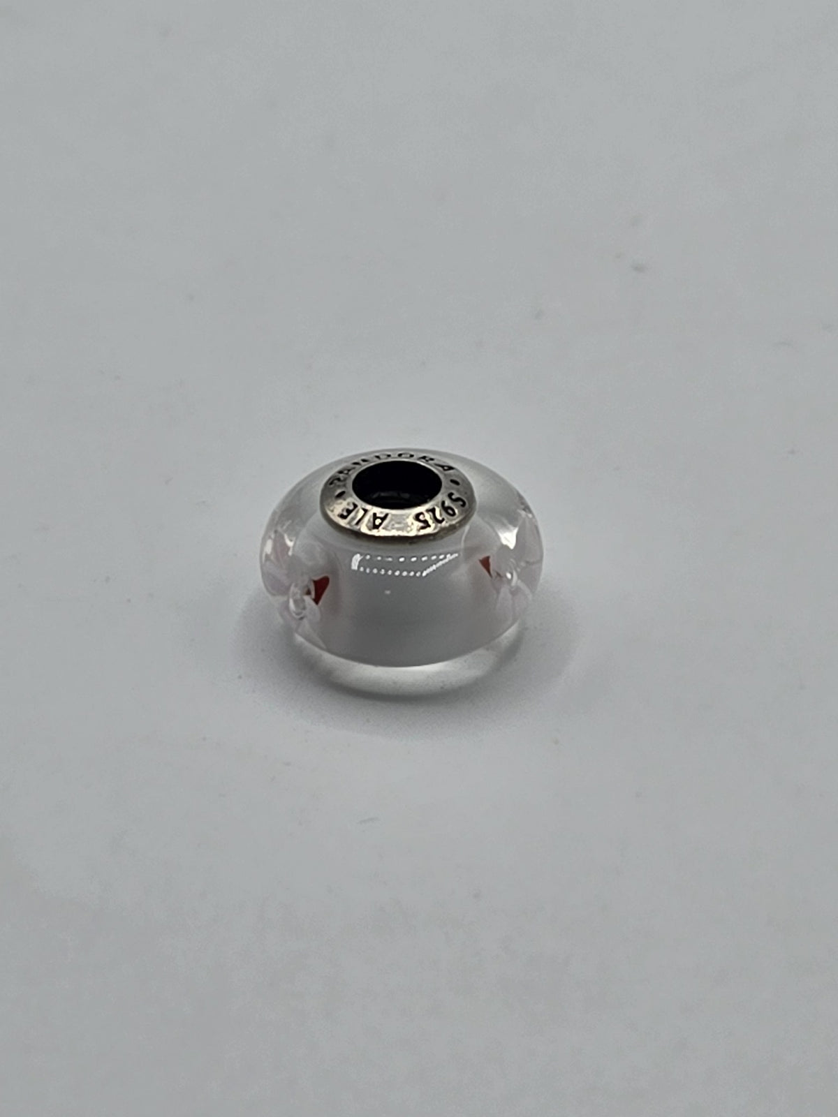 Pandora Milky White and Red Murano Glass Charm on a plain light background