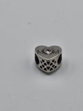 Pandora MOM Openwork Heart Charm on a plain light background