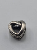 Pandora Openwork Entwined Heart Charm on a plain light background