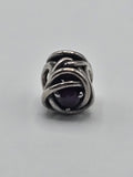 Pandora Openwork Knot Charm with Purple Stone on a plain light background