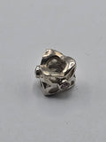 Pandora Openwork Twist Charm with Pink Stones on a plain light background