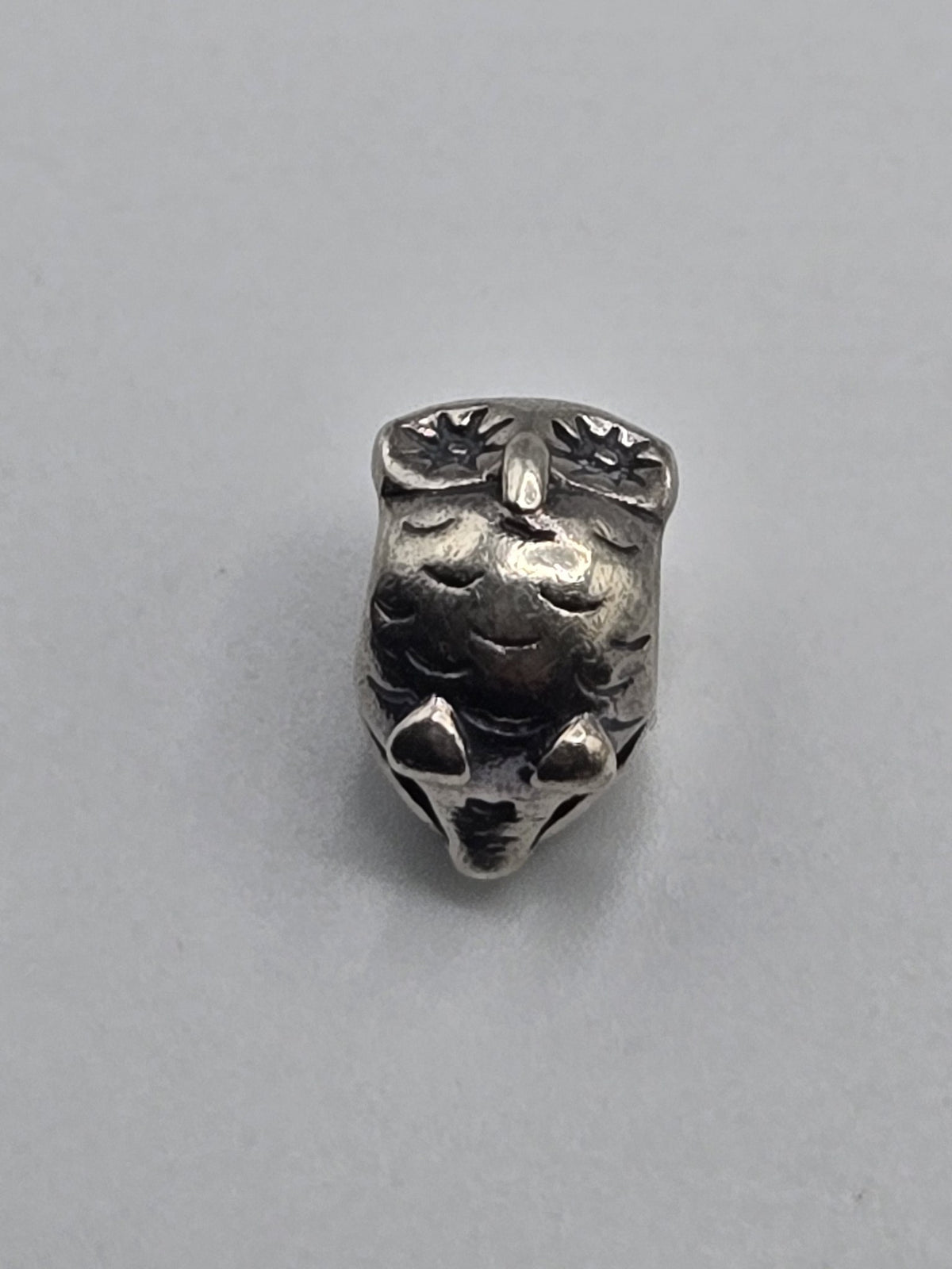 Pandora Owl Charm on a plain light background