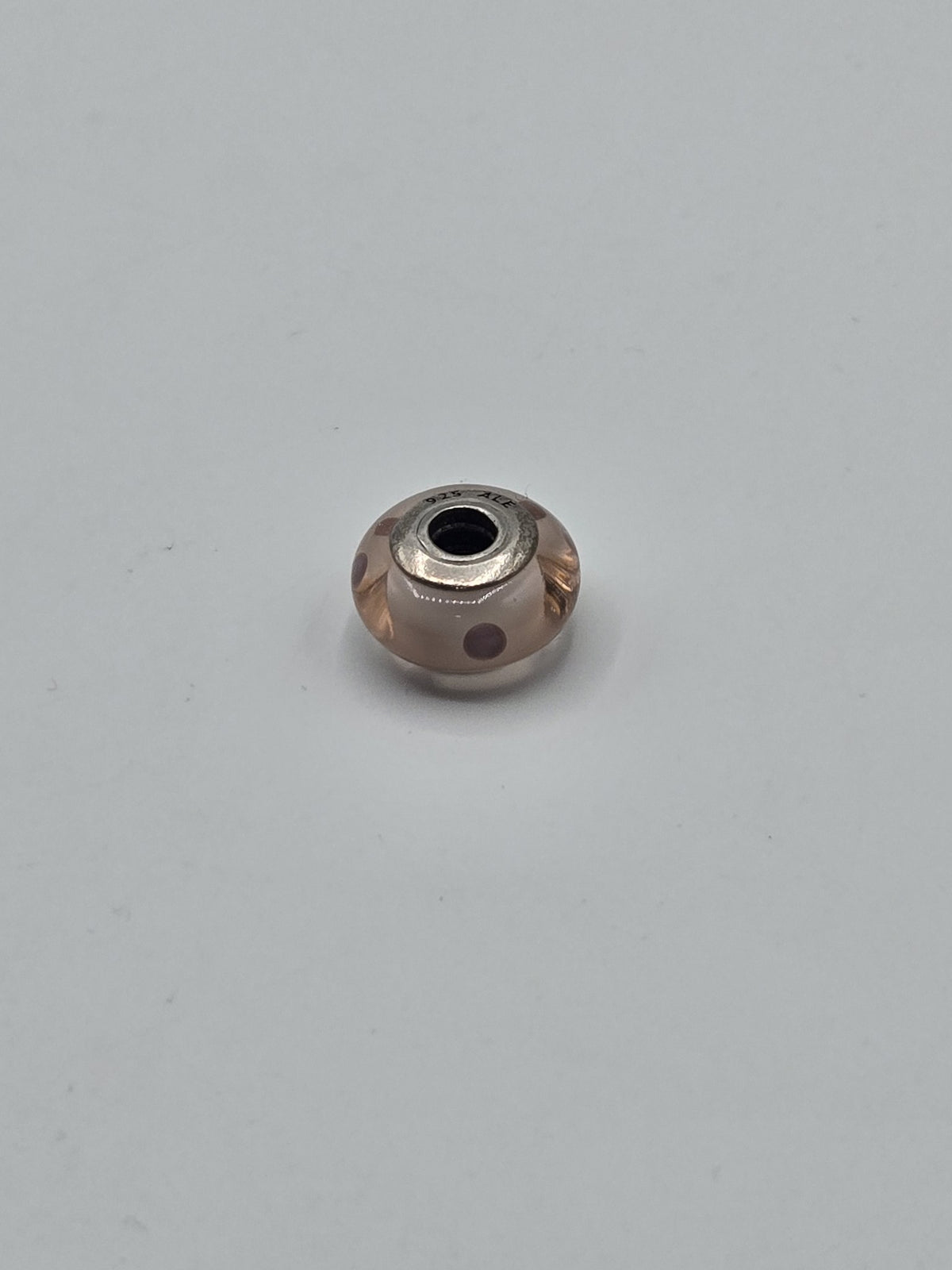 Pandora Pale Peach and Purple Dot Murano Glass Charm on a plain light background