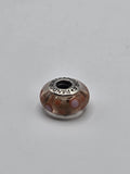 Pandora Peach and Coral Dot Murano Glass Charm on a plain light background